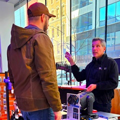 2025-01-22 Barbizon DMXcat-E Demo Day John Demous doing product demo, cityscape behind